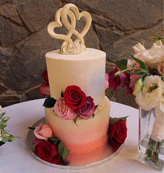 custom-wedding-cakewith-haerts-on-top-and-red-roses-on-dessert-table-temecula